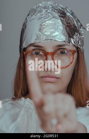 Vertical shot of a young Caucasian female showing disagreement Stock Photo