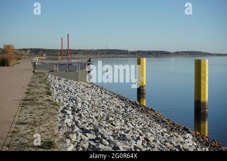 The harbour on Lake Grossaeschener, a former open-cast mine in Brandenburg, shows the change of landscape from mining to lake land Stock Photo