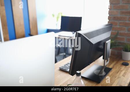 Many computers standing on table in empty classroom Stock Photo