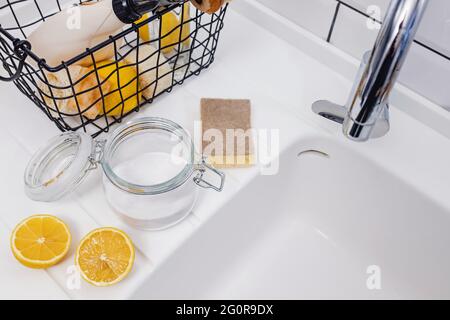 Baking soda and lemons near the sink. Stock Photo