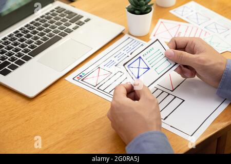 UI Graphic designer creative sketch and planning prototype wireframe for website. Web application development of user interface and user experience co Stock Photo