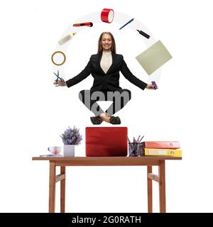 Beautiful young woman, office worker levitating isolated on white studio background with equipment Stock Photo