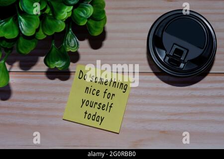 Yellow stick note with coffee on wooden table. Space for text Stock Photo