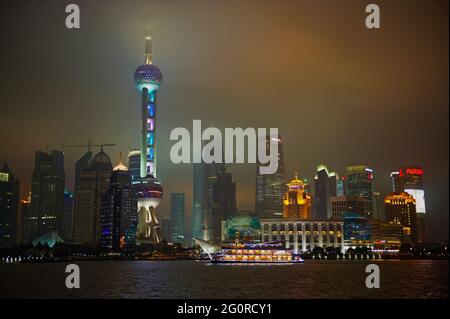 China. Shanghai. The Huangpu River and many of the new towers of Pudong, including the Oriental Pearl TV Tower. Stock Photo