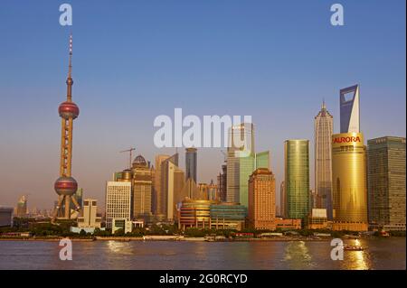 China. Shanghai. The Huangpu River and many of the new towers of Pudong, including the Oriental Pearl TV Tower. Stock Photo