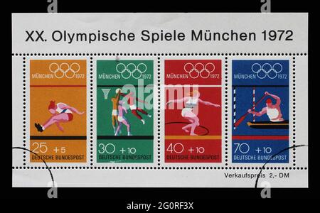 Stamp printed in Germany showing a block of letterheads at the 1972 Summer Olympics in Munich: Olympic rings with the sports motifs: long jump, basket Stock Photo