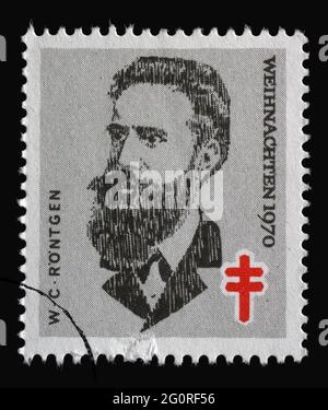 Stamp printed in Germany shows portrait of Wilhelm Conrad Röntgen, Christmas 1970, circa 1970 Stock Photo