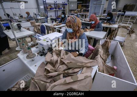 Baghdad, Iraq. 02nd June, 2021. Garment workers work on sewing machines as they produce clothing for the Iraqi Armed Forces members. The factory reopened in 2019 after it was damaged during the Battle of Baghdad in 2003. Credit: Ameer Al Mohammedaw/dpa/Alamy Live News Stock Photo