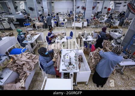 Baghdad, Iraq. 02nd June, 2021. Garment workers work on sewing machines as they produce clothing for the Iraqi Armed Forces members. The factory reopened in 2019 after it was damaged during the Battle of Baghdad in 2003. Credit: Ameer Al Mohammedaw/dpa/Alamy Live News Stock Photo