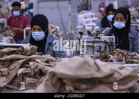 Baghdad, Iraq. 02nd June, 2021. Garment workers work on sewing machines as they produce clothing for the Iraqi Armed Forces members. The factory reopened in 2019 after it was damaged during the Battle of Baghdad in 2003. Credit: Ameer Al Mohammedaw/dpa/Alamy Live News Stock Photo
