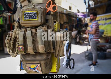 Baghdad, Iraq. 02nd June, 2021. A military vest hangs in front of a military clothing store. Credit: Ameer Al Mohammedaw/dpa/Alamy Live News Stock Photo