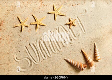 Summer inscription on a sandy background, decorated with starfish and exotic seashells Stock Photo