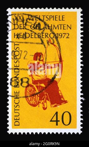 Stamp printed in Germany showing Wheelchair archery, 21st International Games for Paralysed, Heidelberg, circa 1972 Stock Photo