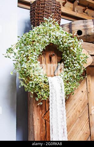 Easter wreath on wooden door. Spring home decorations. Stock Photo