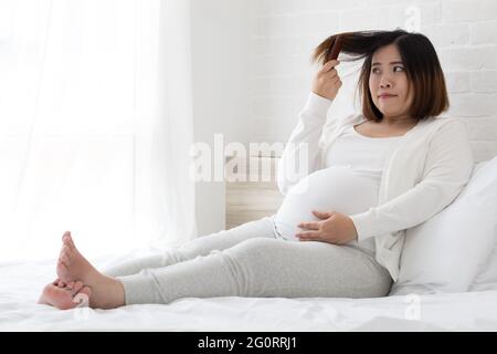 Asian pregnant woman can not making new hair color because it affects the fetus Stock Photo
