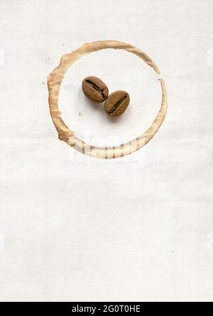 Spot on the cup and coffee beans on paper Stock Photo