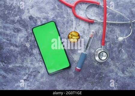 Insulin pens smart phone , pills and stethoscope on black background  Stock Photo