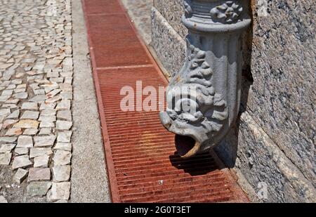 Metallic downspout in shape of beast head, Gargoyle drain, Downtown Rio Stock Photo