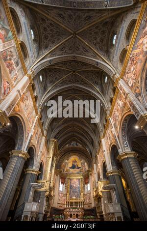 Cremona, Italy - June 2, 2021: symmetrical interior view of Santa Maria Assunta cathedral, people are visible in the distance. Stock Photo