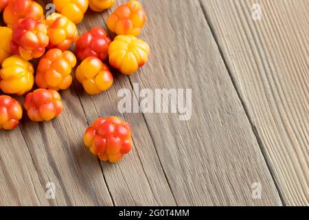 Fresh ripe cloudberries on a wooden table close-up Stock Photo