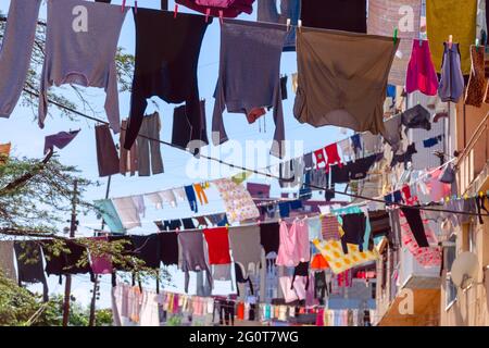 Washed clothes are hanging out to dry in the sun. Georgian courtyard with drying clothes on the line. Batumi. Stock Photo