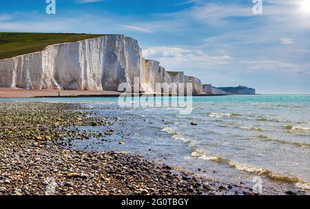 The sun shining on the Seven Sisters in East Sussex, looking along the line of chalk cliffs from Cuckmere Haven to Birling Gap. Stock Photo