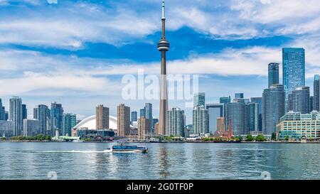 The Toronto city skyline during the daytime and seen from the Lake Ontario, Canada. The image includes the CN Tower which is a symbol of the country Stock Photo