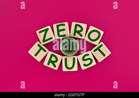 photo on zero trust theme. wooden cubes with the words "zero trust", on pink background Stock Photo