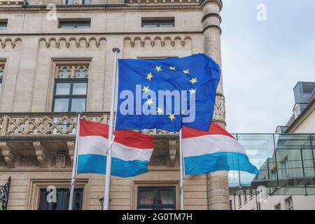 European Union and Luxembourg flags waving in front of the Chamber of Deputies - Luxembourg City, Luxembourg Stock Photo