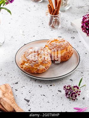 Fresh baked choux pastry cakes with sugar Stock Photo