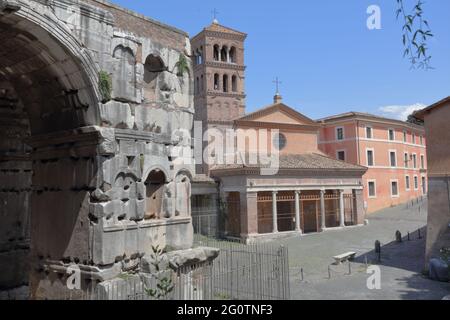 View to the San Giorgio in Velabro church in Rome, Italy from behind of the Arch of Janus (left). By legend, here the she-wolf found Romulus and Remus Stock Photo