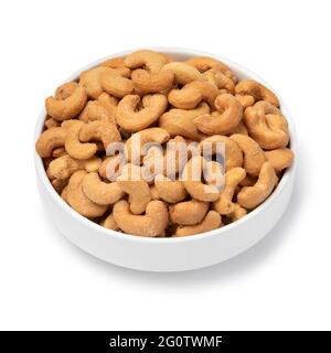 White bowl with with salted cashew nuts close up isolateds on white background Stock Photo