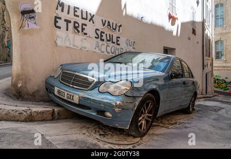Battered Mercedes-Benz car parked in a tiny alley of Le Panier, oldest quarter of Marseille, France Stock Photo