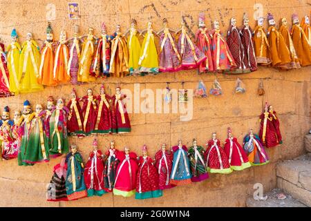 Traditional King and queen, called Raja Rani, handmade puppets or Katputli Sets are hanging from wall inside Jaislamer fort, Rajasthan, India. Stock Photo
