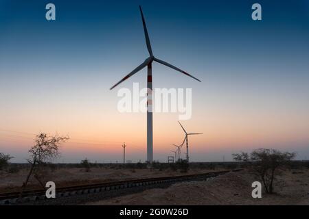 Wind mills before dawn with pre dawn light in the sky in background, Thar desert, Jaisalmer, Rajasthan, India Stock Photo