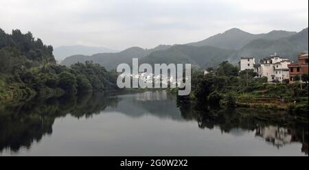 Wangkou in Wuyuan County, Jiangxi Province, China. Wangkou is an ancient town known for its Tang Dynasty architecture. Scenic view with river. Stock Photo