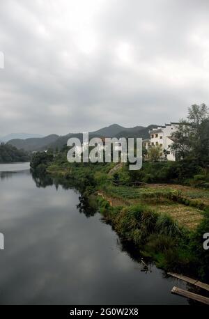Wangkou in Wuyuan County, Jiangxi Province, China. Wangkou is an ancient town known for its Tang Dynasty architecture. Scenic view with river. Stock Photo
