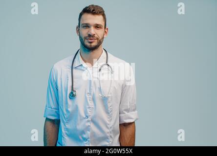 Positive young european male doctor in studio Stock Photo