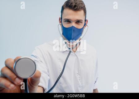European male doctor using stethoscope in studio Stock Photo