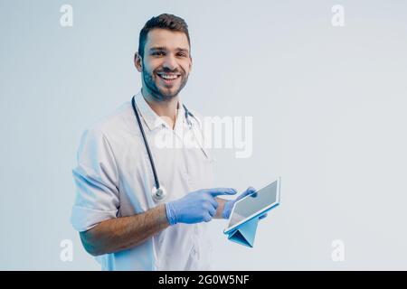 Smiling european male doctor using digital tablet Stock Photo