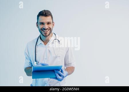 Smiling european male doctor with digital tablet Stock Photo