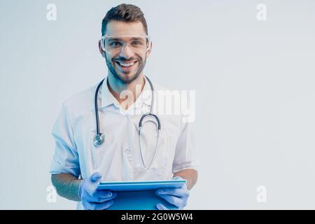 Smiling european male doctor with digital tablet Stock Photo