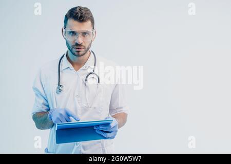 Serious european male doctor with digital tablet Stock Photo