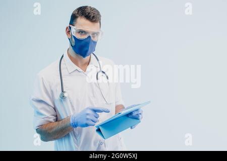 European male doctor with digital tablet in studio Stock Photo