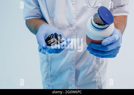Male doctor hands holding bottle of pills Stock Photo
