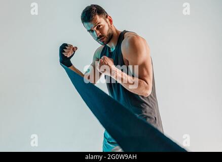 Concentrated boxer with boxing bandage on hand Stock Photo