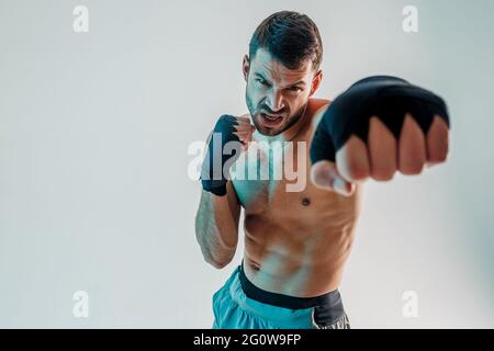 Angry young bearded european boxer is boxing Stock Photo