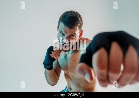 Aggressive young bearded european boxer is boxing Stock Photo