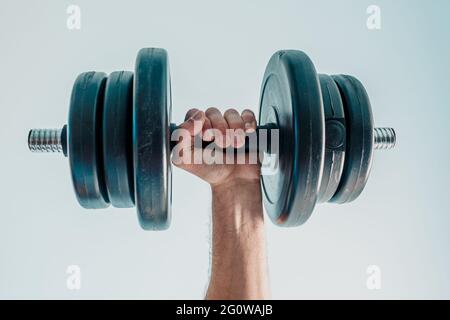 Close up of sportsman hand holding dumbbell Stock Photo
