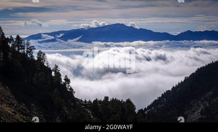 Fog at the bottom of the Cerdanya valley, seen from the Engorgs cirque. In the background, the Tosa d'Alp summit, Cerdanya, Catalonia, Spain, Pyrenees Stock Photo
